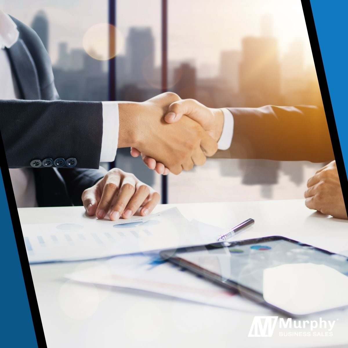 two business professionals shaking hands in a modern office overlooking the city skyline
